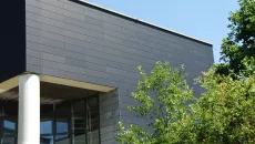 The UniMail building at the University of Neuchâtel with its dark photovoltaic façade.